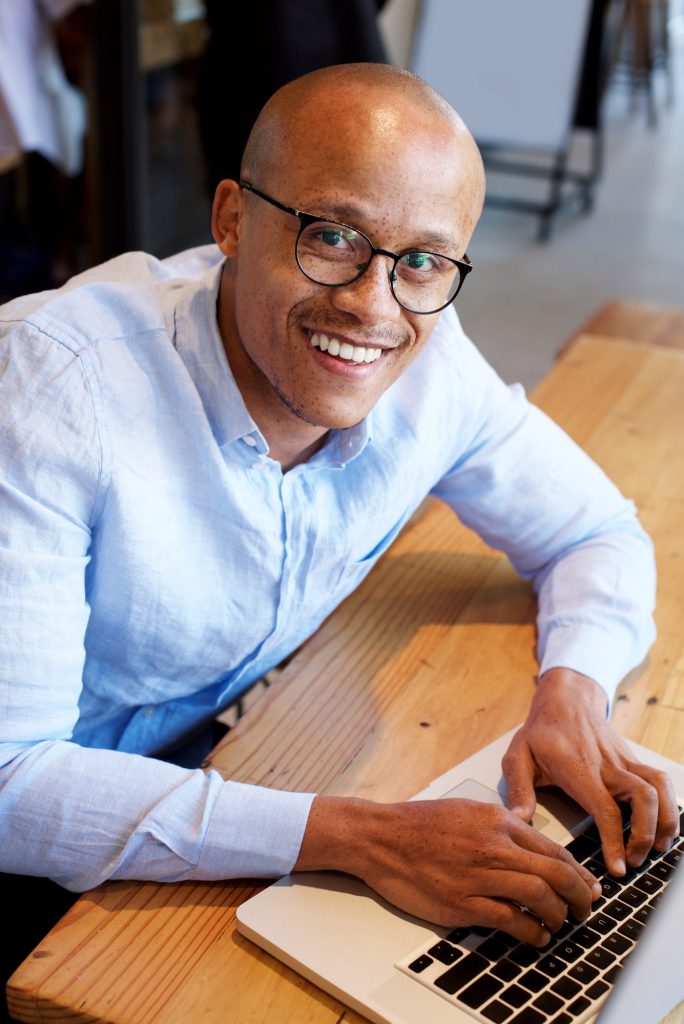 black businessman sitting with laptop